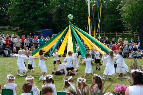Children perform a ribbon dance around a maypole in Barwick-in-Elmet, England, c. 2011.