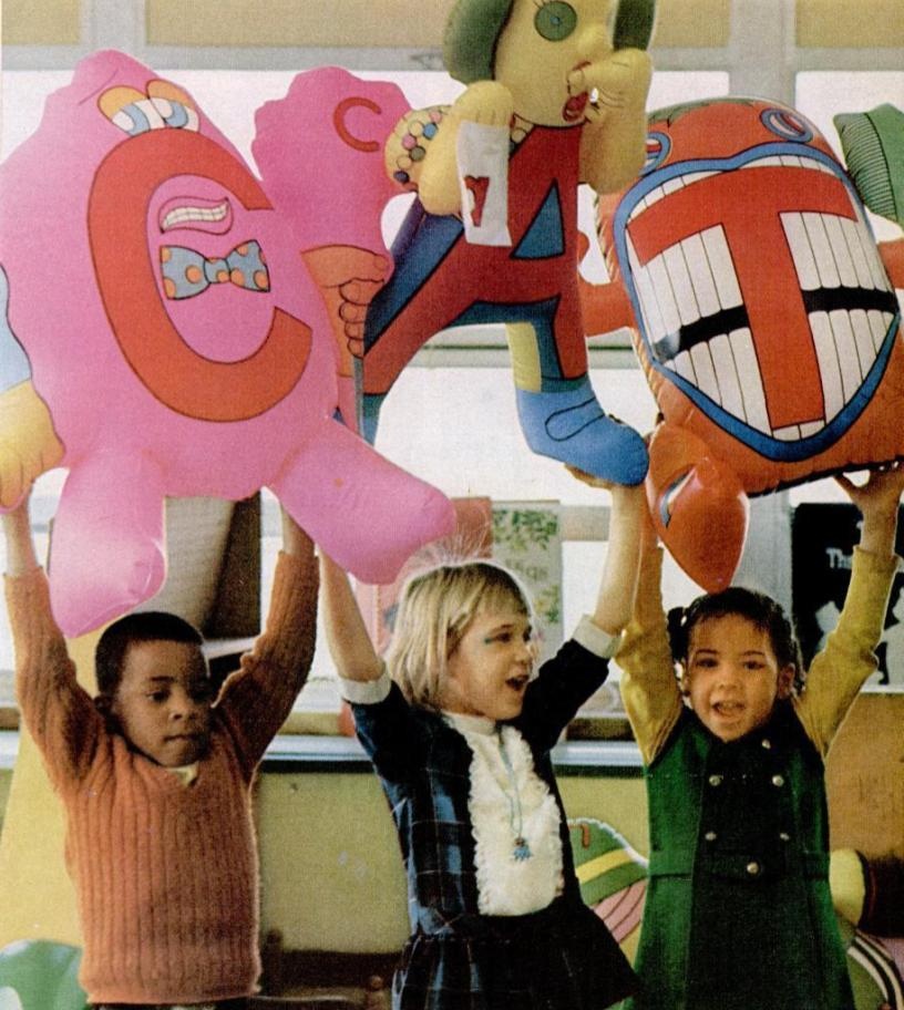 Children playing with inflatable Letter People toys