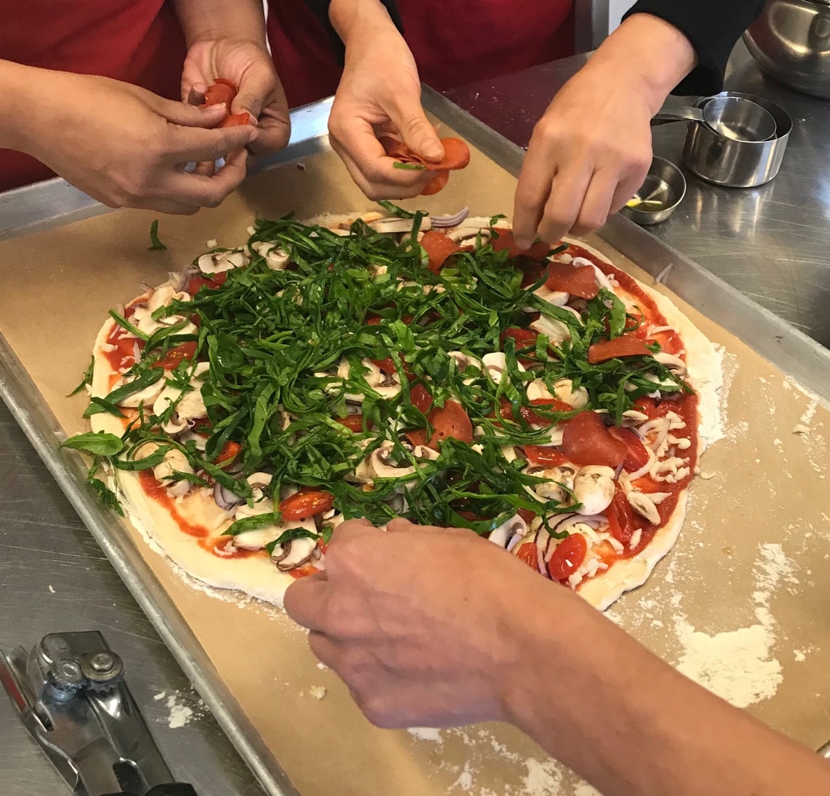 Today we are sharing a recipe from our Edible Alphabet English cooking curriculum that is a hit with participants year after year: homemade pizza.