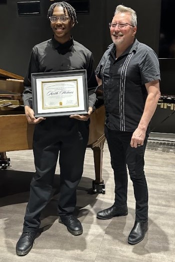 The 2025 recipient of the Edwin A. Fleisher Collection scholarship is Keith Holmes. Fleisher Collection Curator, Gary Galván, presented the award during Play on Philly's June 6 recital. 