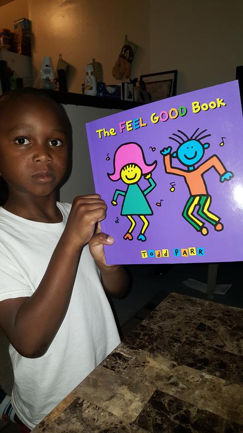 Maurice shows off a book he got at the September Words at Play Block Party.