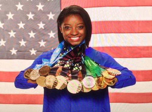 Simone Biles pictured with her many, MANY medals!