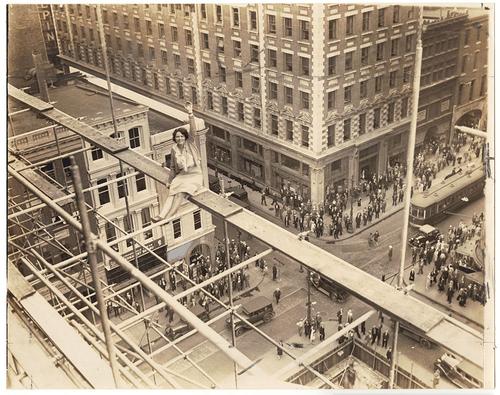 Vivian Shirley sitting on scaffolding atop the Federal Reserve Bank (under construction), 6/14/1930