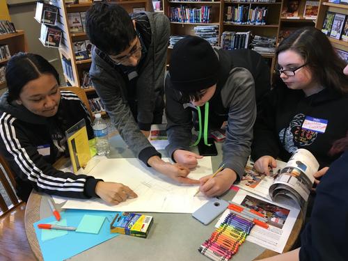 Teens working on a design for the library.