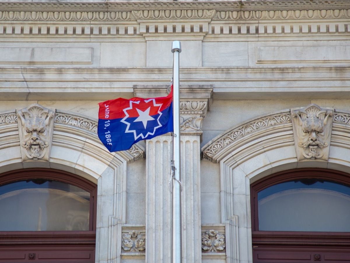 Juneteenth flag flying outside of City Hall