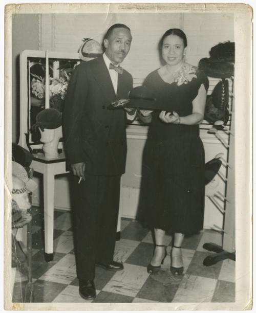   Mae Reeves and her husband Joel pose with her hats at Mae's Millinery in Philadelphia, circa 1953. Collection of the Smithsonian National Museum of African American History and Culture, Gift from Mae Reeves and her children, Donna Limerick and William Mincey, Jr. 