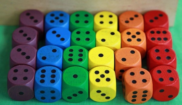 four sets of six colored dice arranged in a rainbow