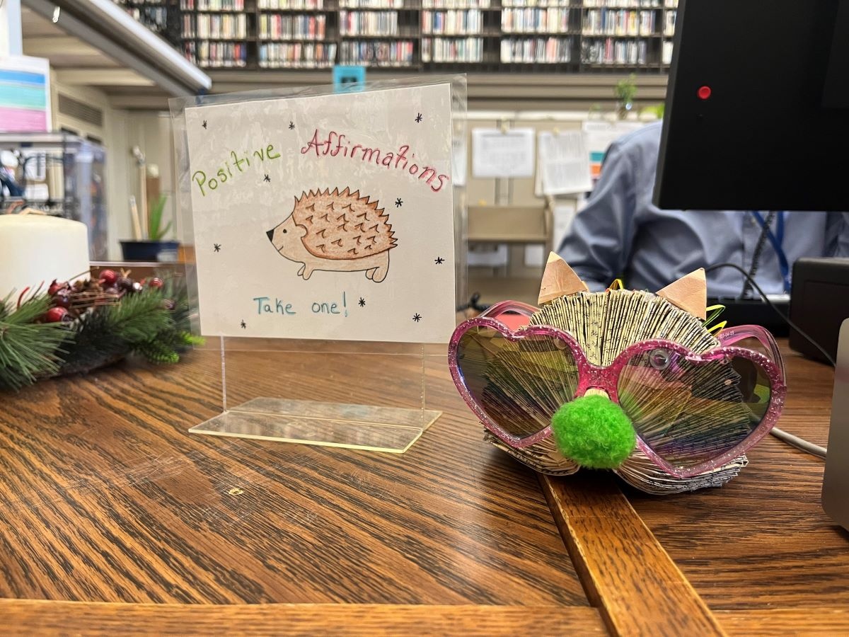 positive affirmation cards next to sunglasses on desk