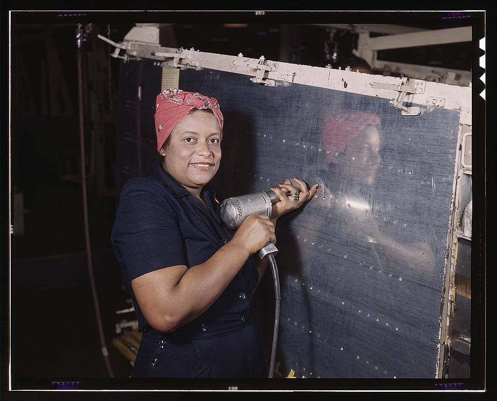 Operating a hand drill at Vultee-Nashville, woman works on a 