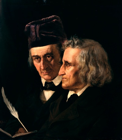 Two men stand shoulder-to-shoulder, with a quill and open book.