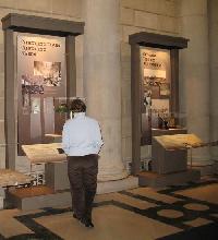 A Vistor Admires One of the Original Reading Room's Brass Lamps.