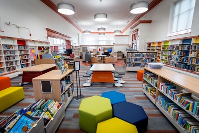 colorful bookshelves with seating in middle of room