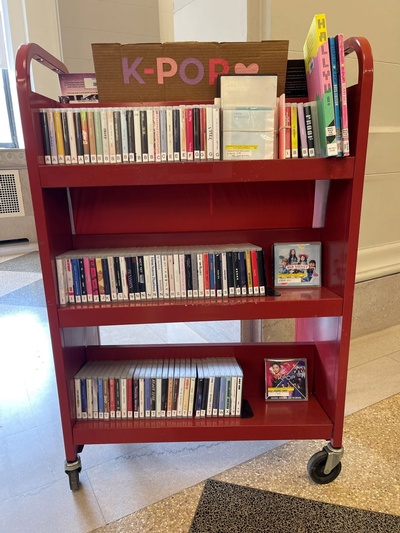 K-Pop listening materials on a cart